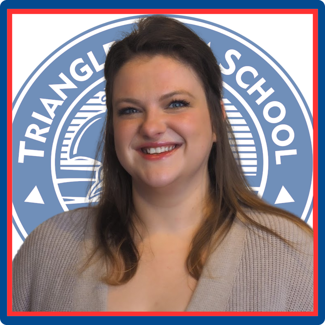 A woman is smiling in front of a triangle school logo
