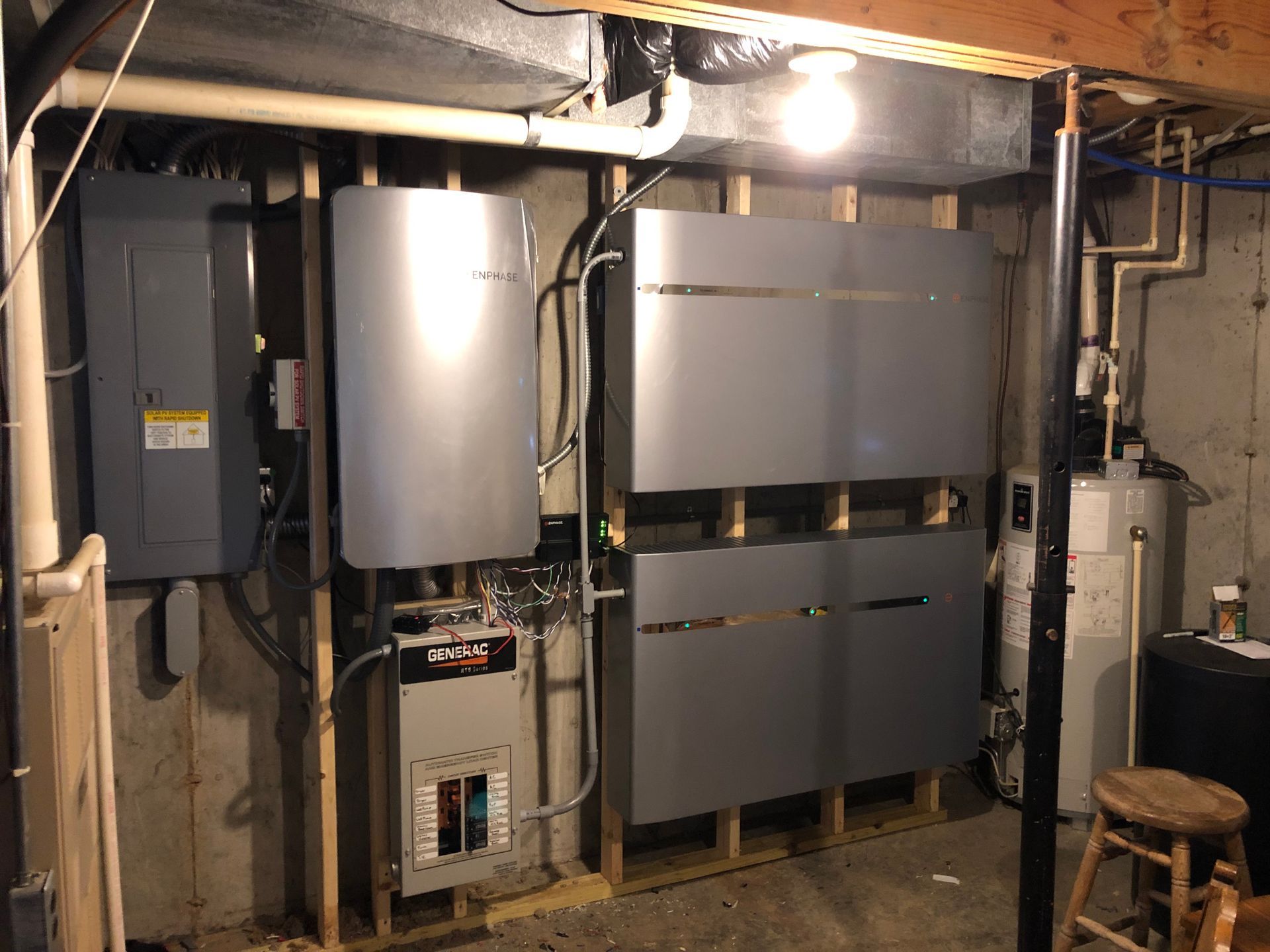 A basement with a lot of electrical equipment and a stool