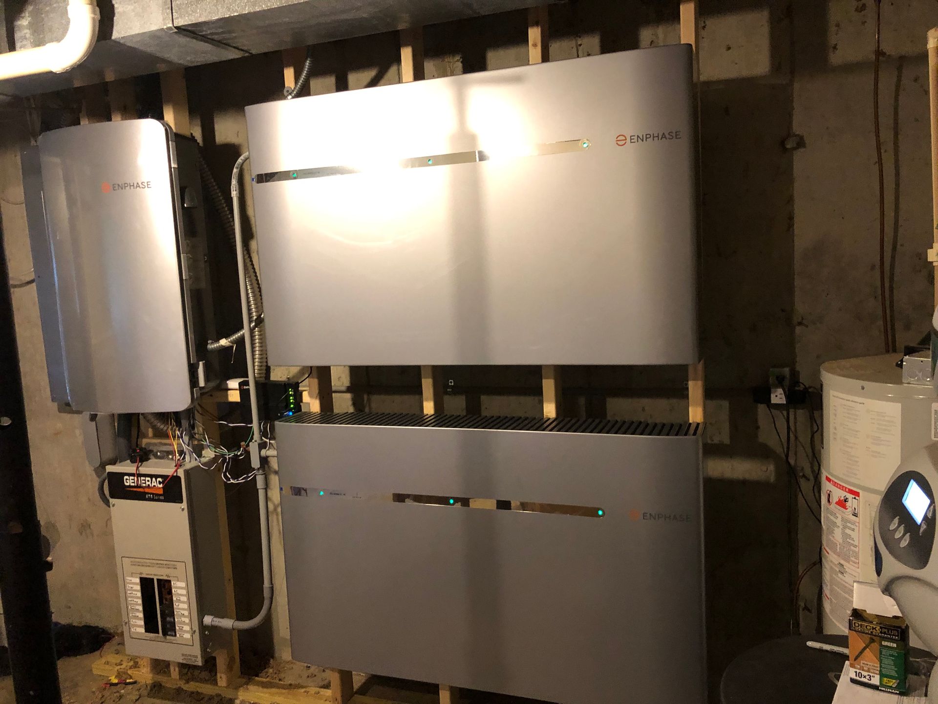 A row of stainless steel appliances are sitting on top of each other in a basement.