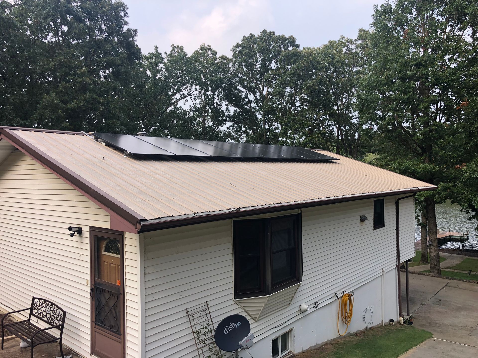 A white house with solar panels on the roof