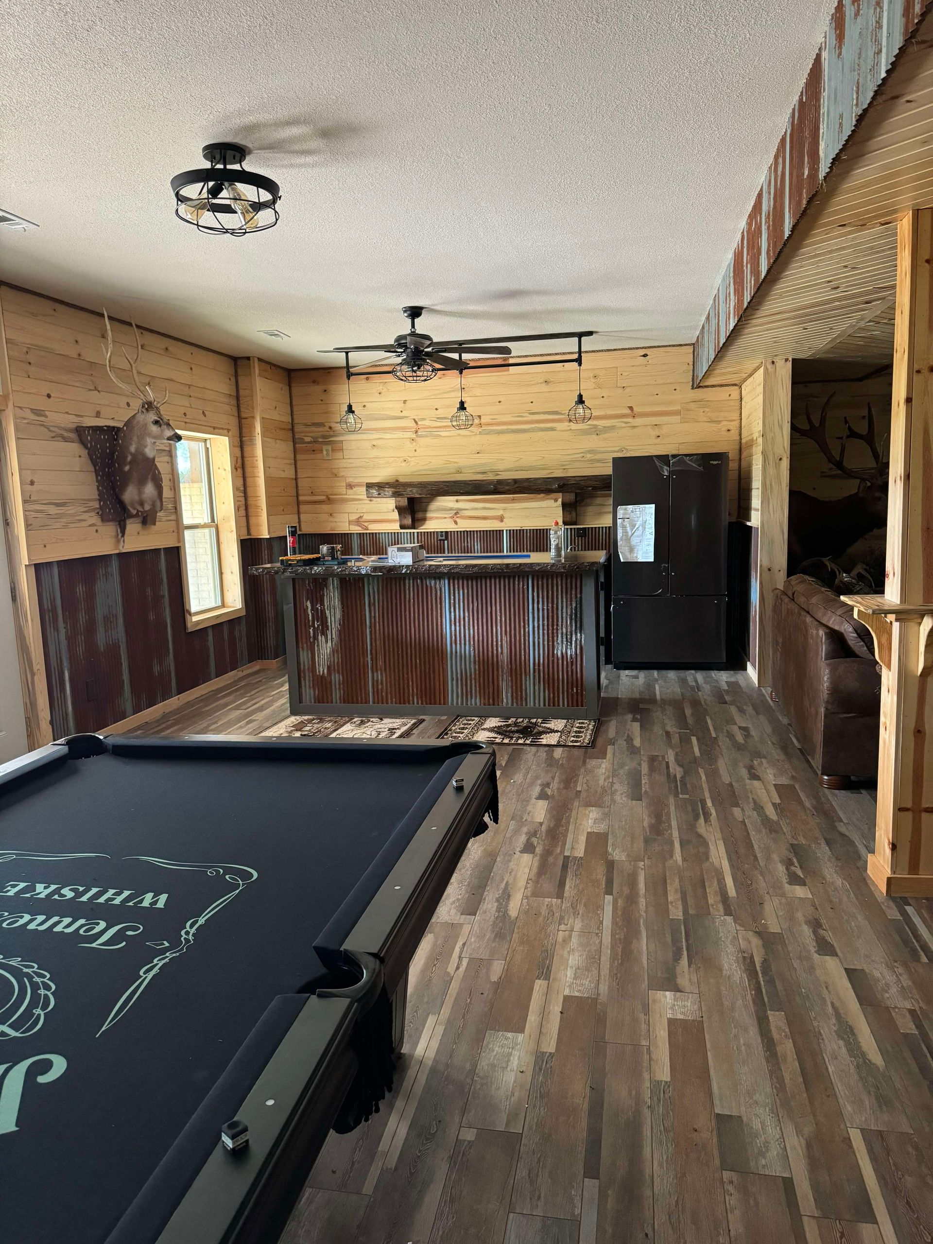 There is a pool table in the middle of the room.