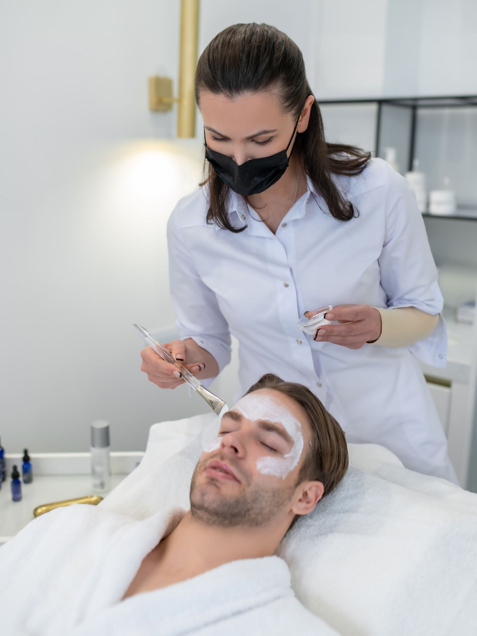 a man is getting a facial treatment at a beauty salon .