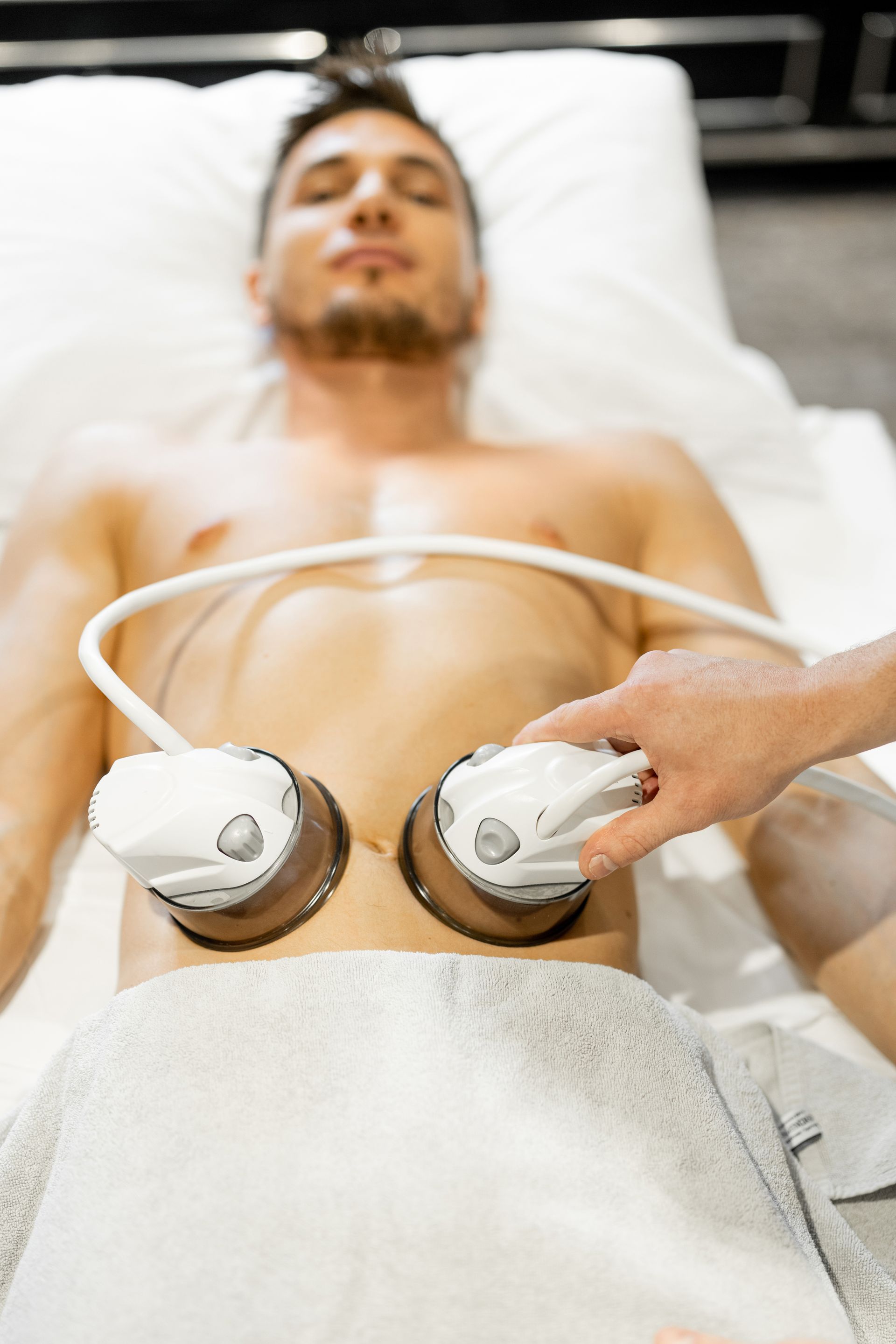 a man is getting an ultrasound on his stomach in a spa .