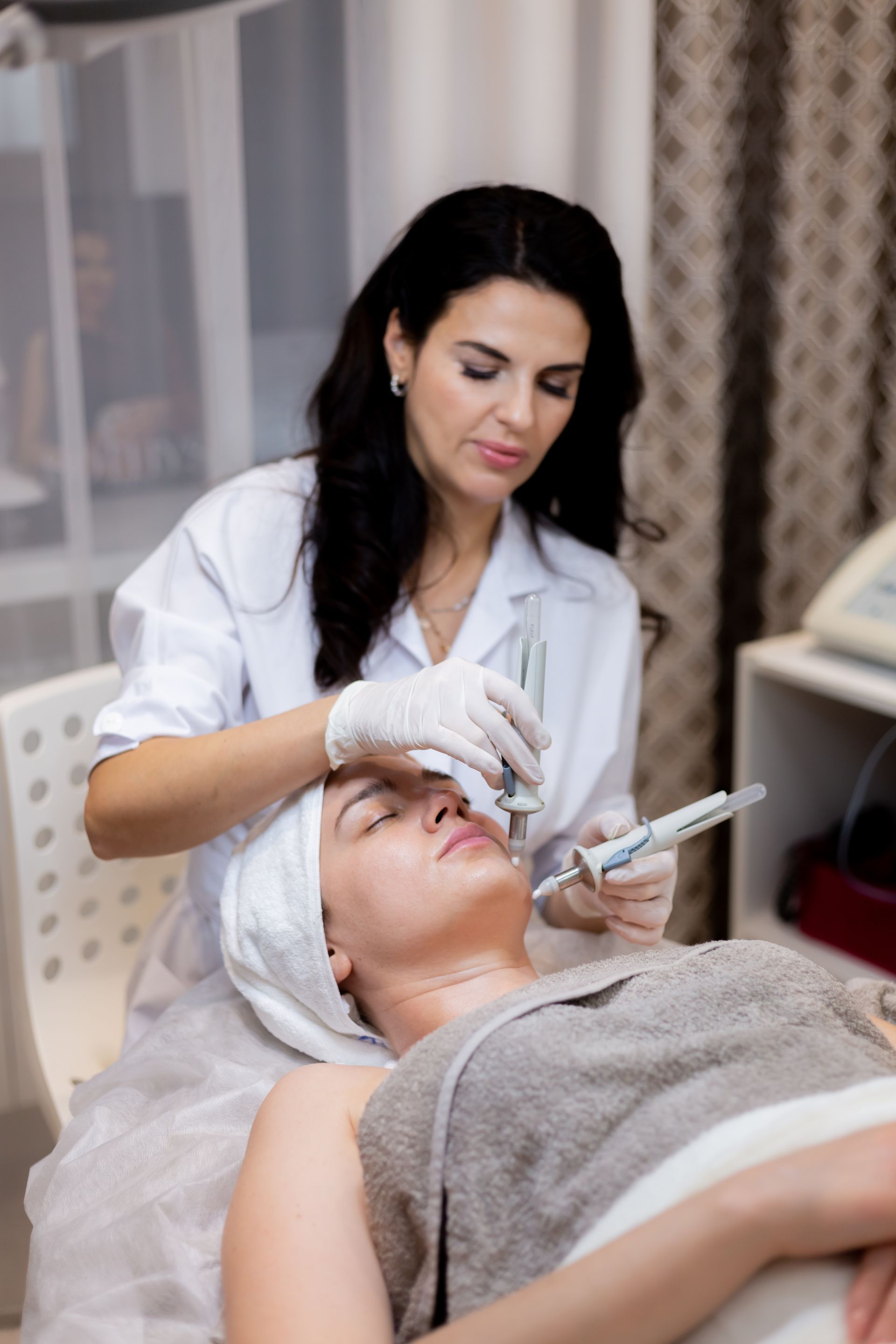a woman is getting a facial treatment at a beauty salon .