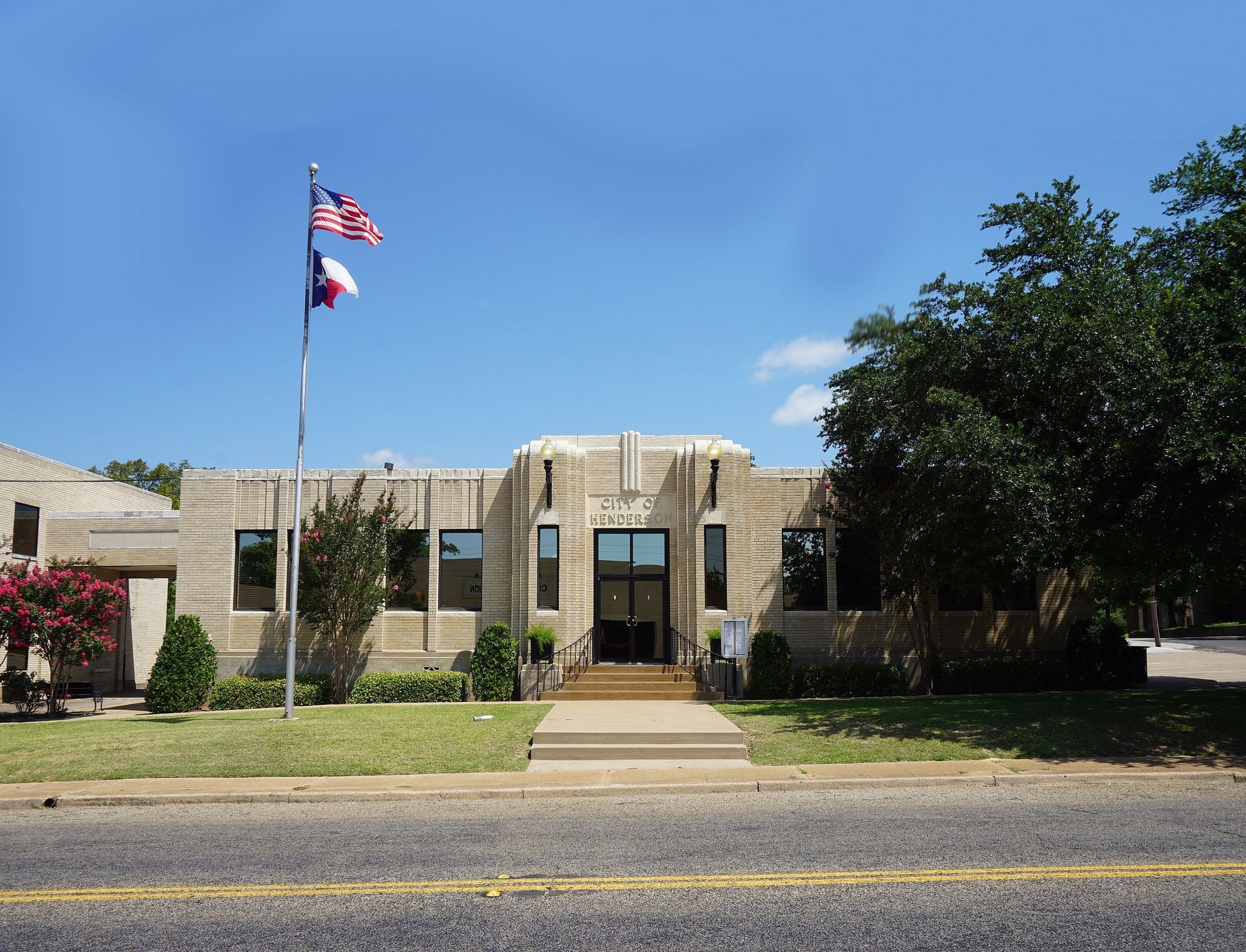 A texas flag is flying in front of a building