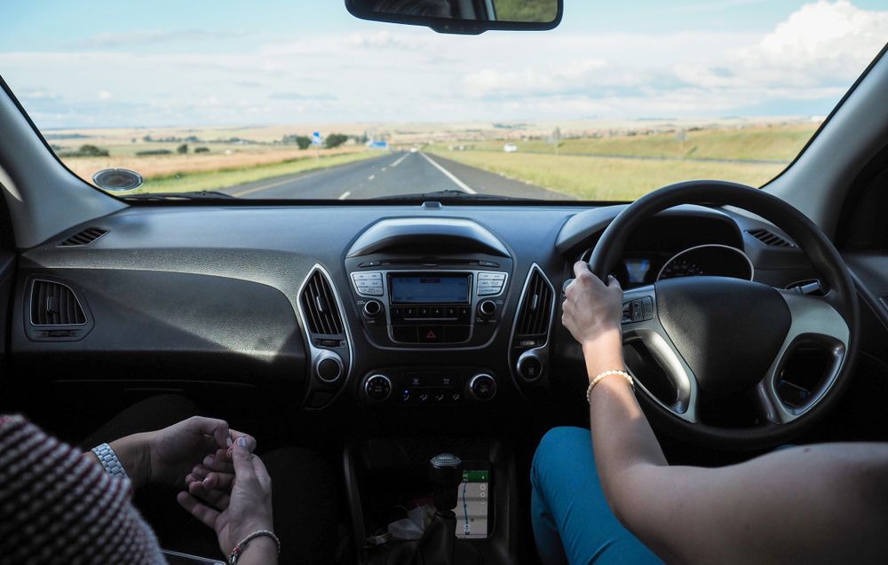A Woman Is Driving A Car Down A Highway — Taminda Smash Repairs In Taminda, NSW