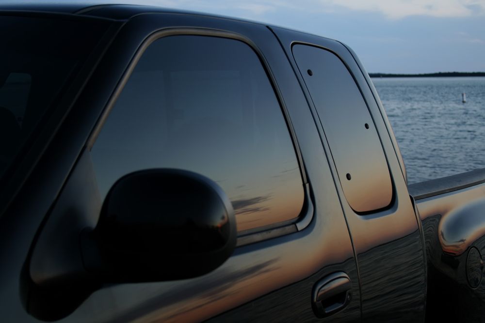 A Black Truck Is Parked In Front Of A Body Of Water — Taminda Smash Repairs In Quirindi, NSW