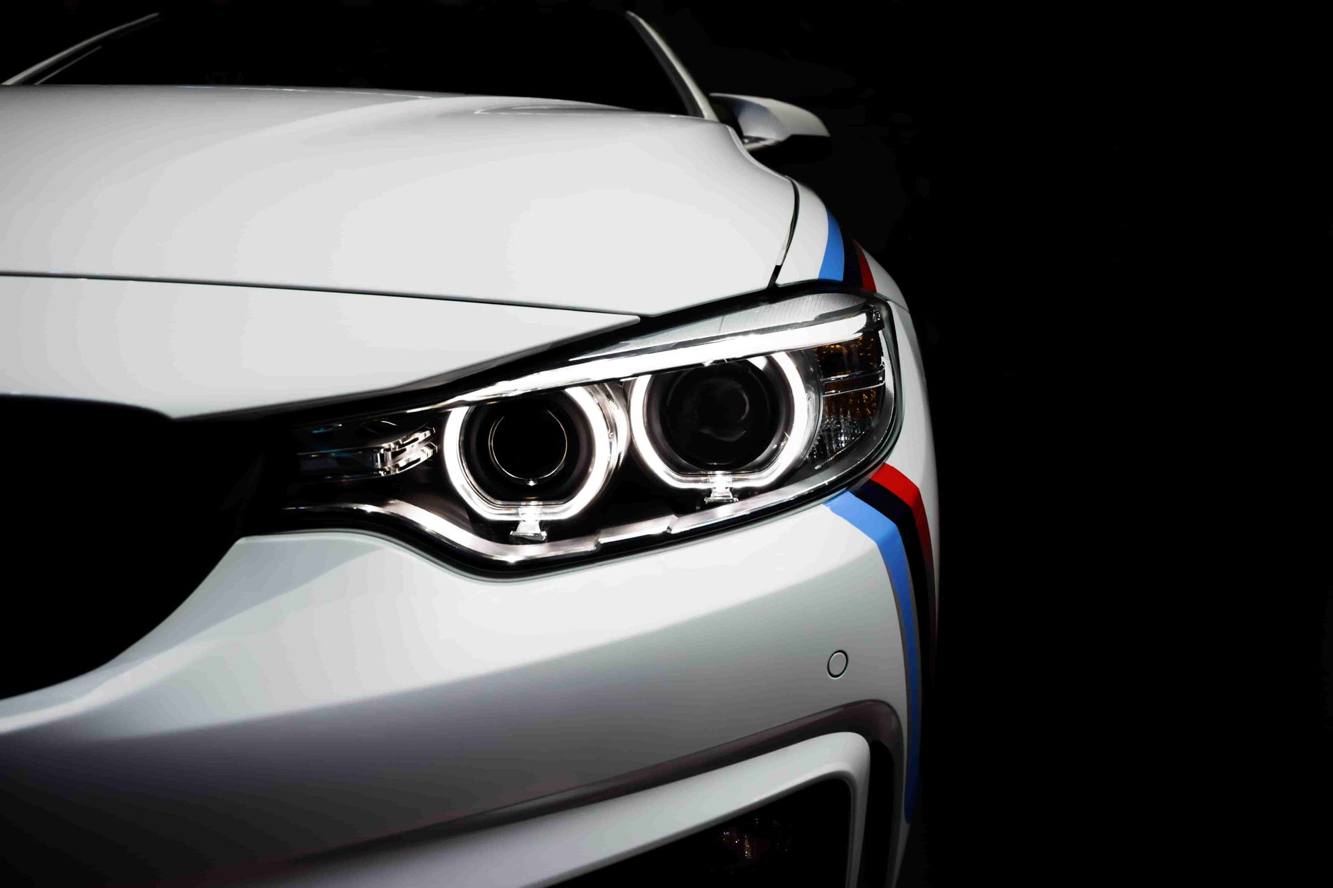 A Close Up Of A White Cars Headlights On A Black Background — Taminda Smash Repairs In Taminda, NSW