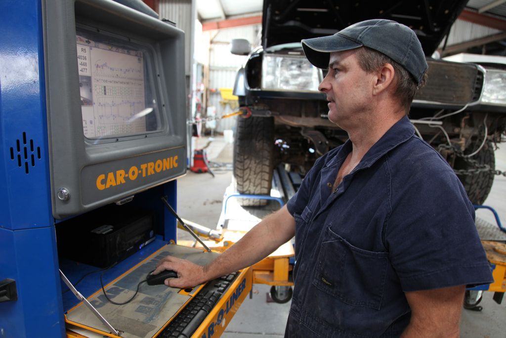 A Man Standing In Front Of A Machine — Taminda Smash Repairs In Taminda, NSW