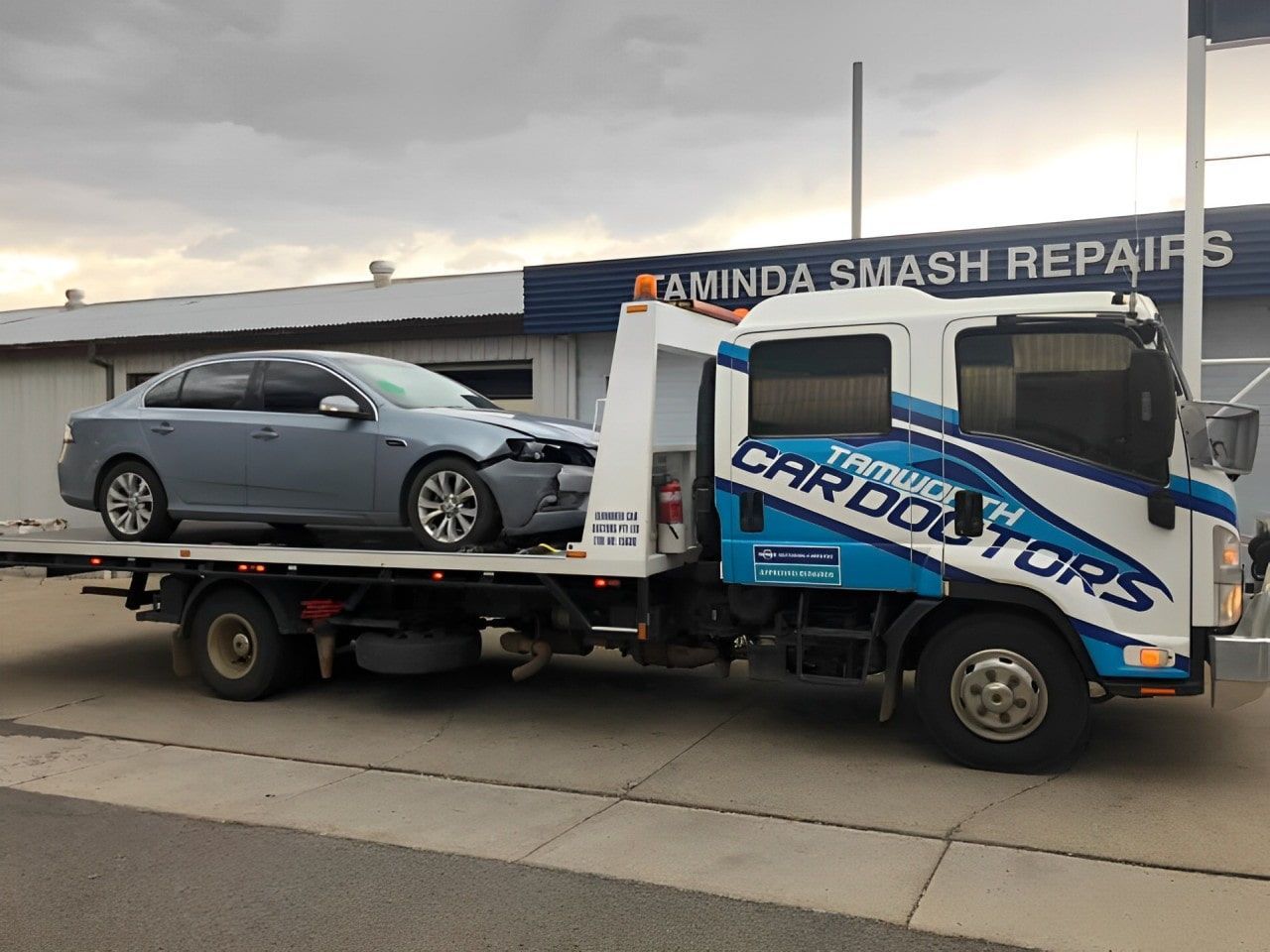 A Car Is Being Towed By A Tow Truck — Taminda Smash Repairs In Taminda, NSW