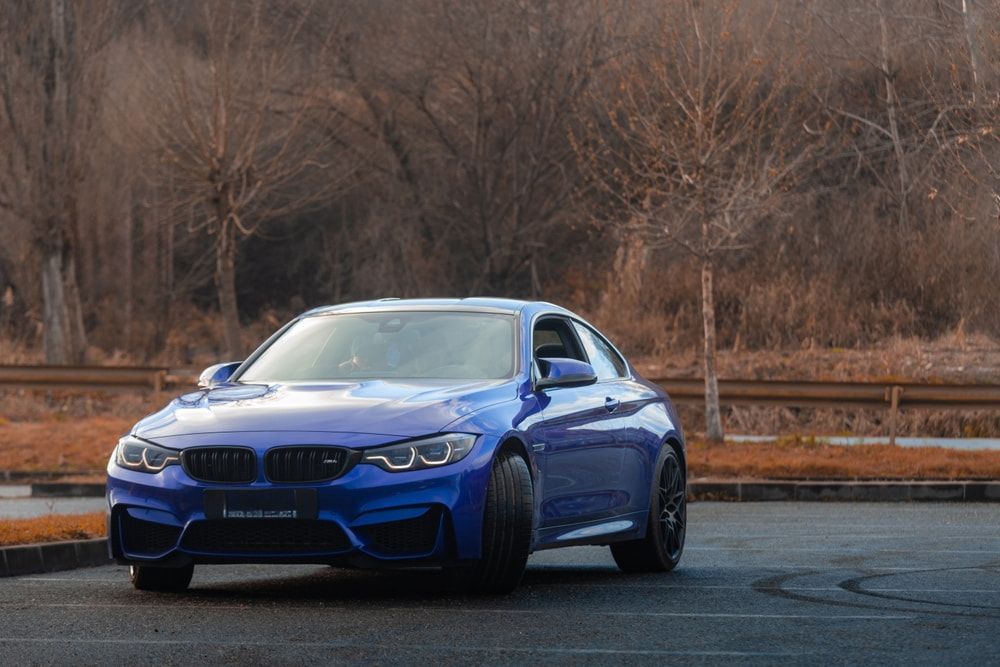 A Blue BMW M4 Is Parked In A Parking Lot — Taminda Smash Repairs In Taminda, NSW
