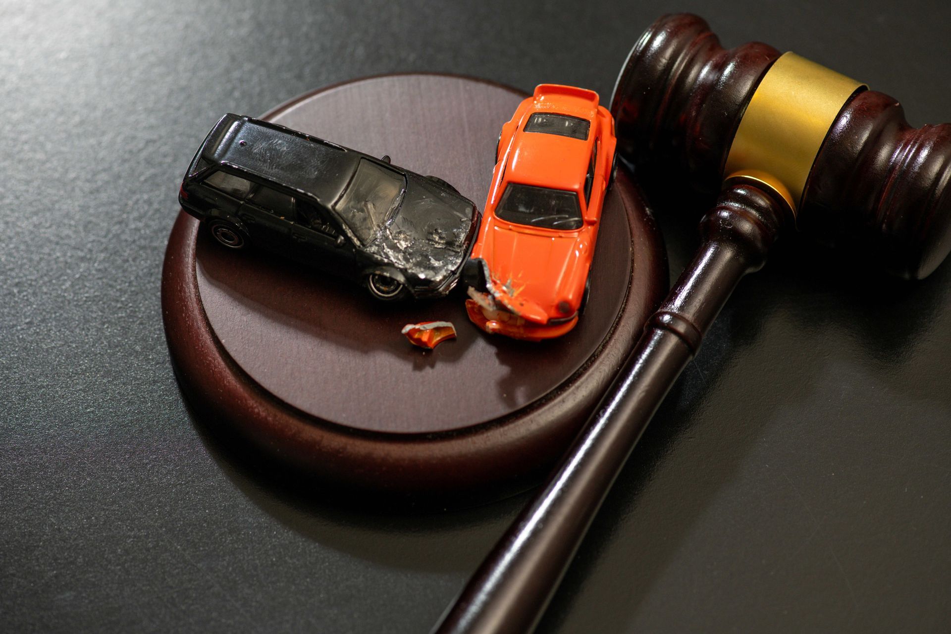 A gavel and damaged cars.