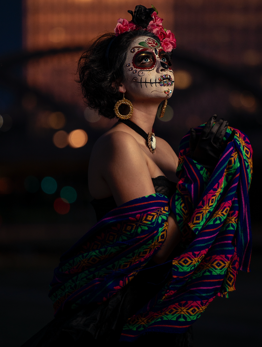 Person with face painted in traditional Sugar Skull markings