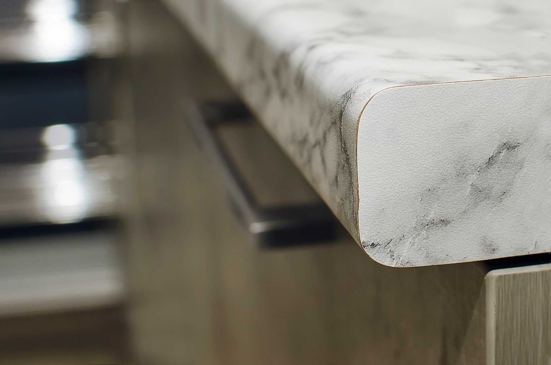 A close up of a marble counter top in a kitchen.