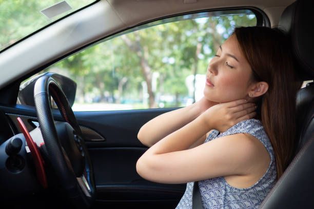 A woman having pain in her neck after a car accident.