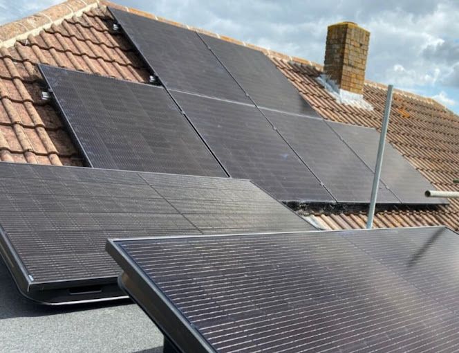 A row of solar panels on the roof of a house