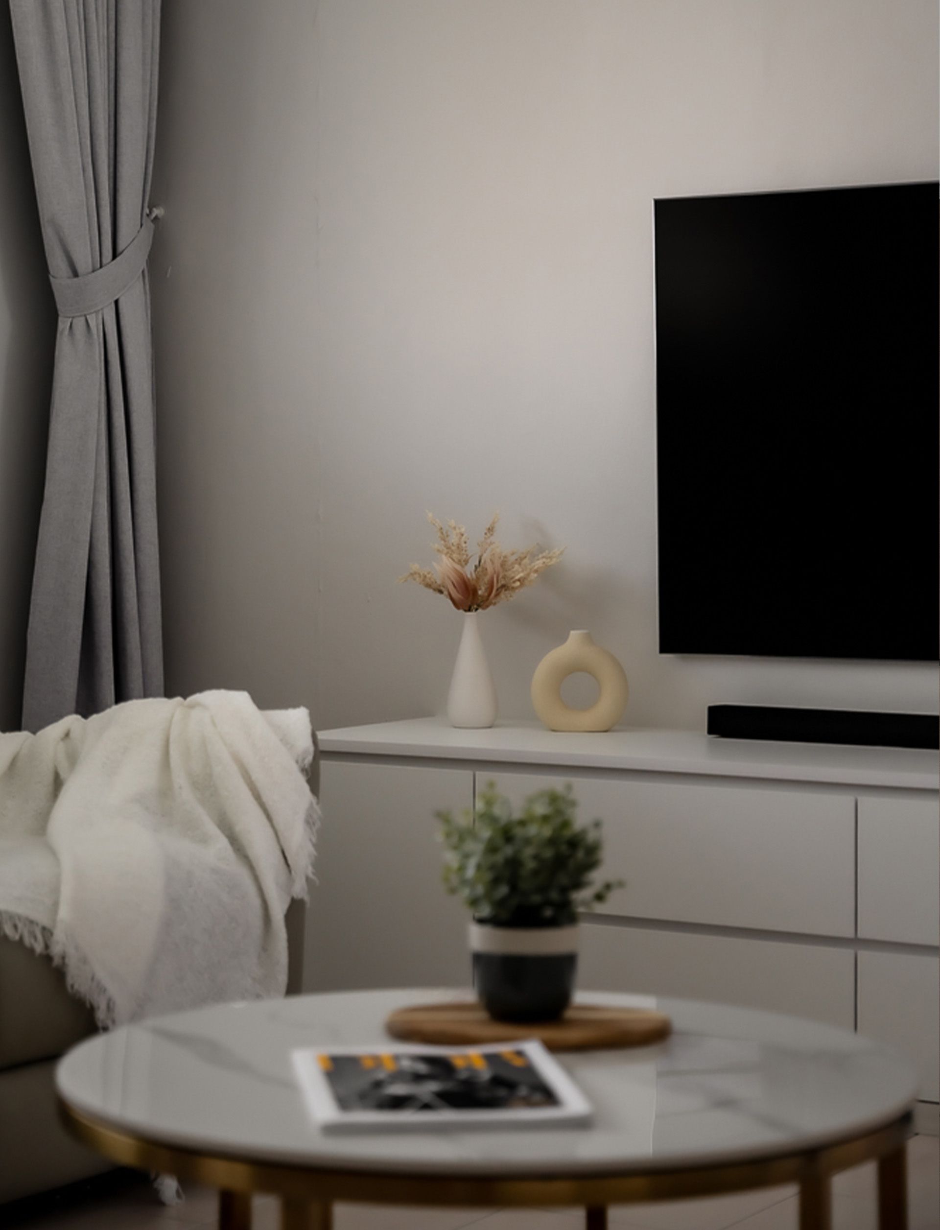 A living room with a couch a table and a television