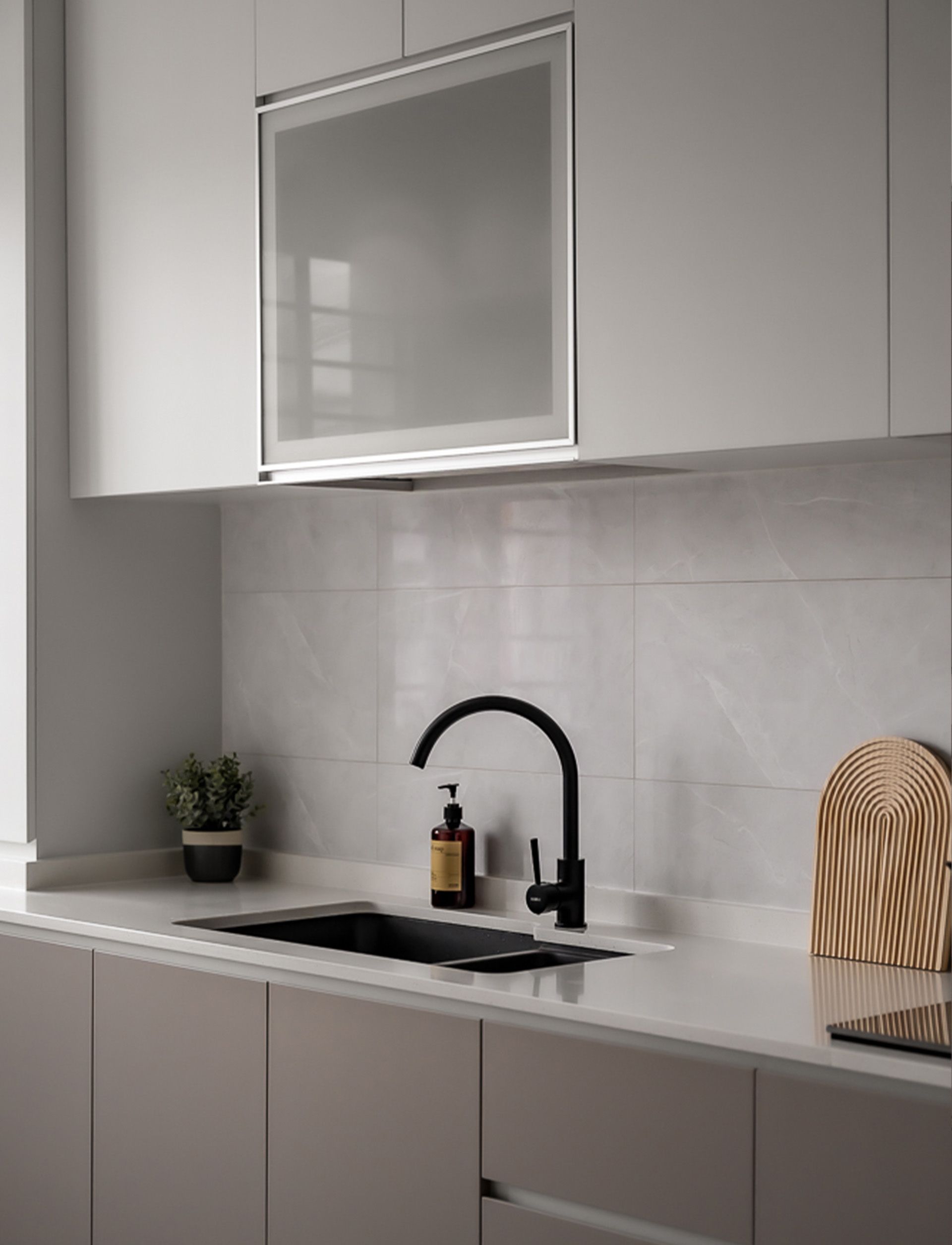 A kitchen with white cabinets , a sink , and a window.