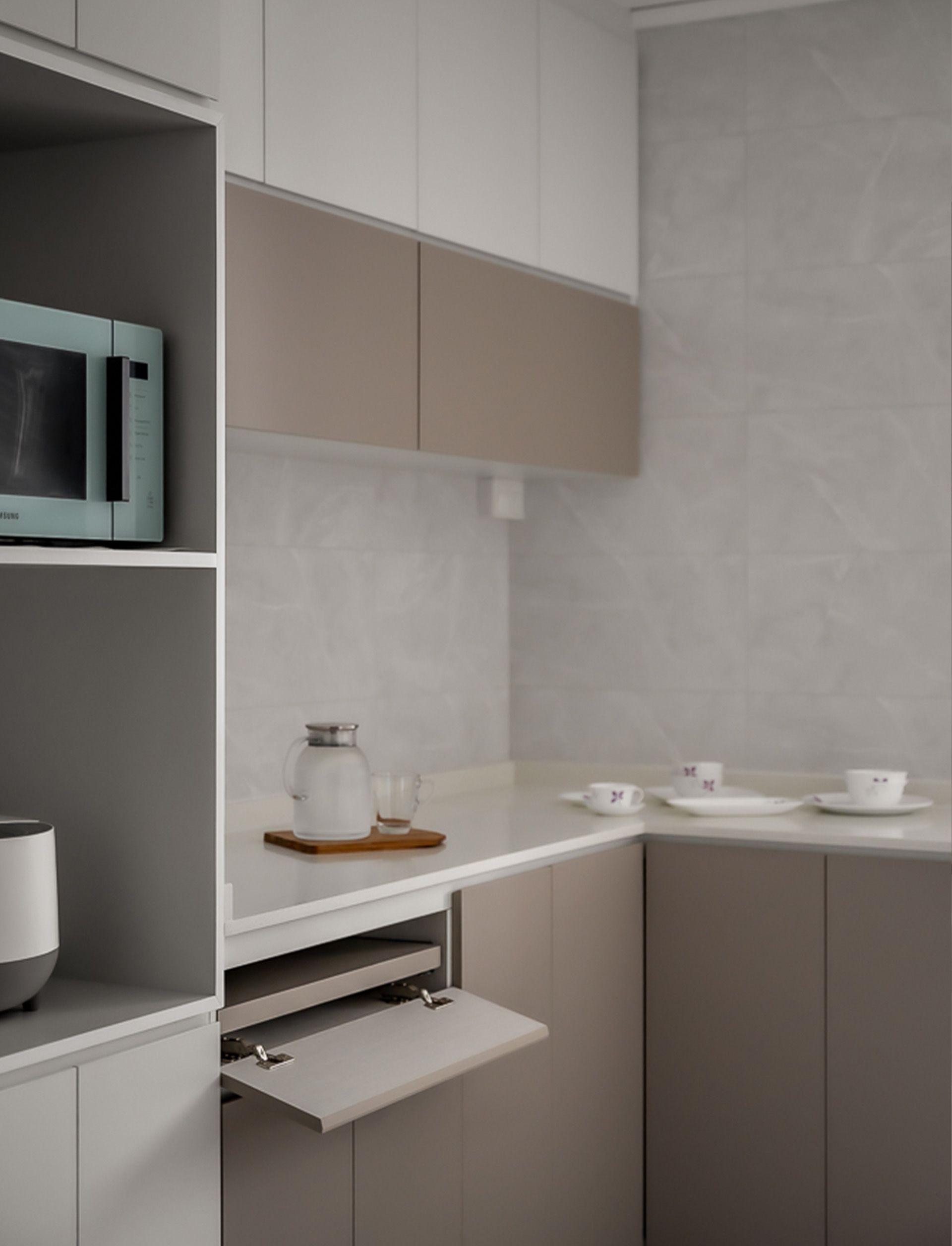 A kitchen with a microwave and a coffee pot on the counter