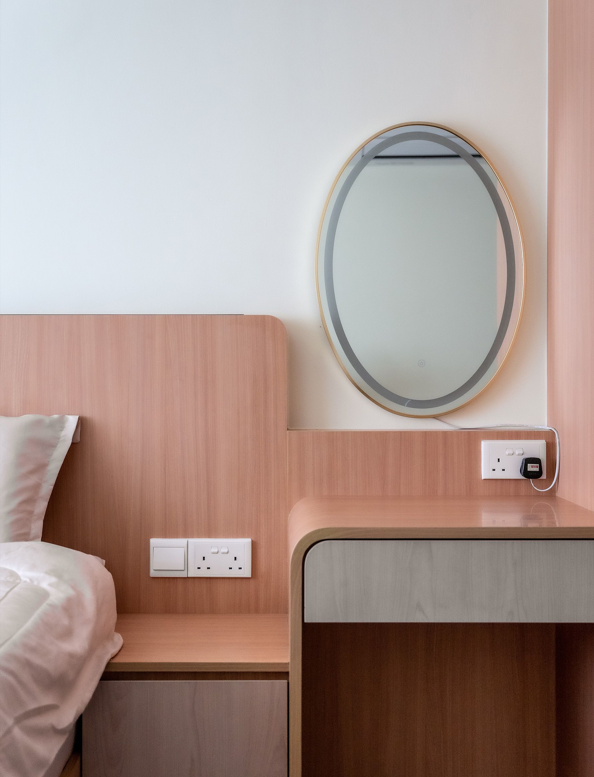 A bedroom with a bed , dresser , mirror and nightstand