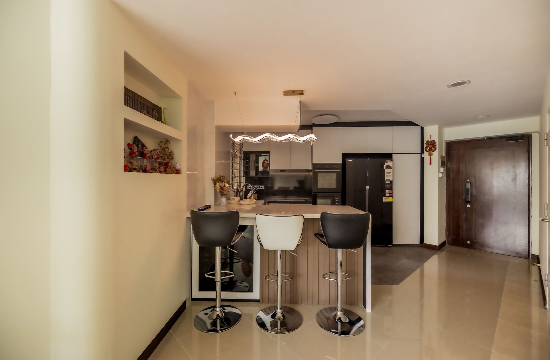 A kitchen with a table and chairs and a refrigerator.