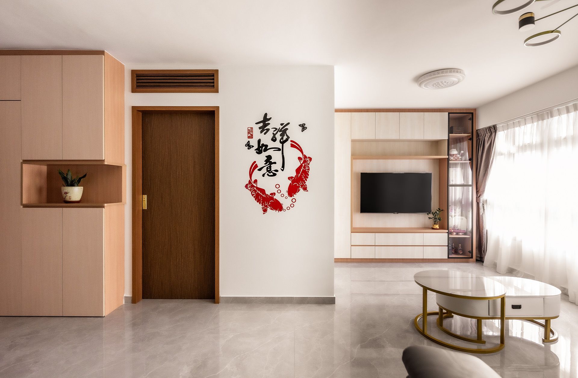 A living room with a table and a tv on the wall