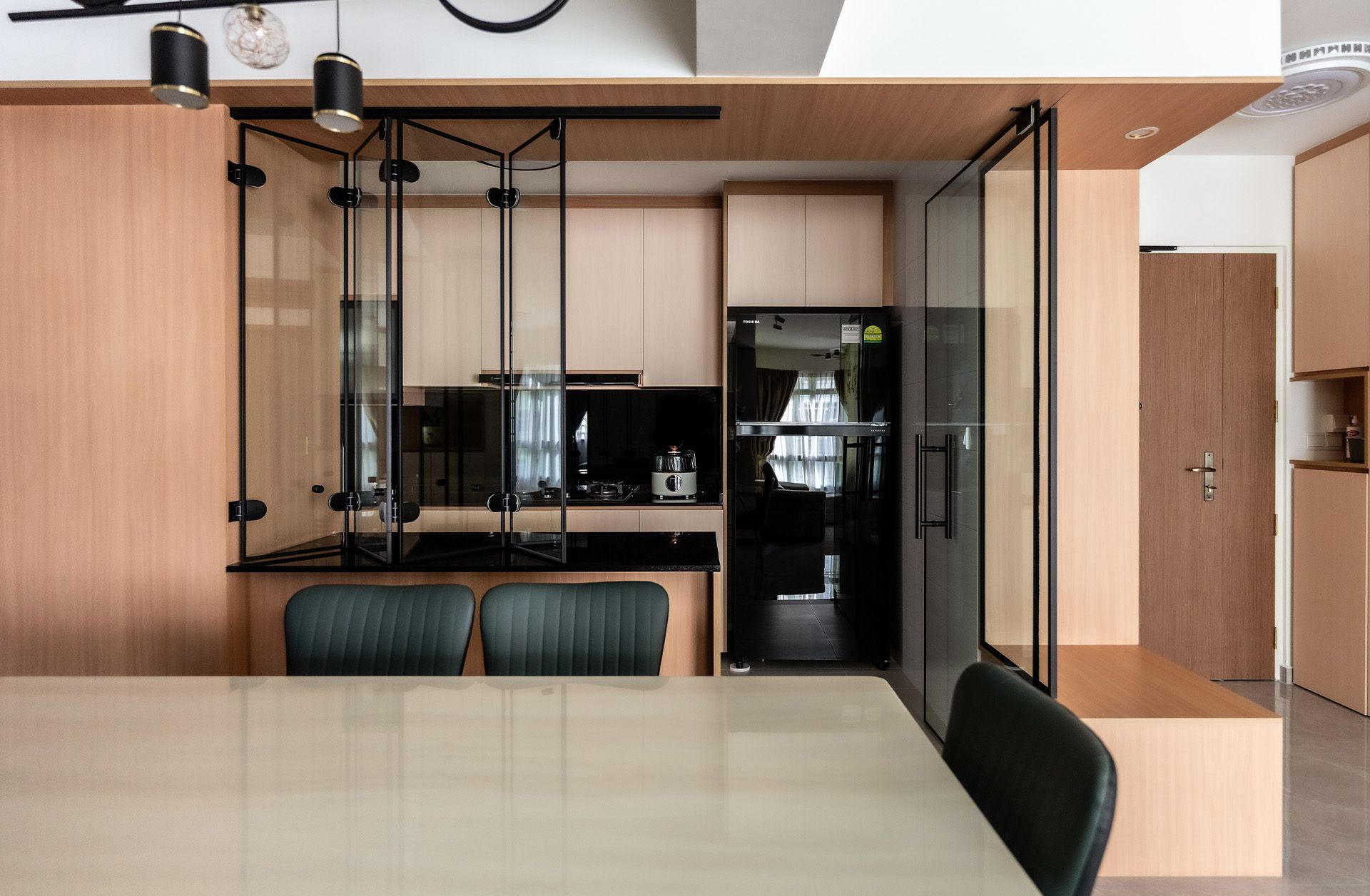 A kitchen with a table and chairs and a refrigerator.