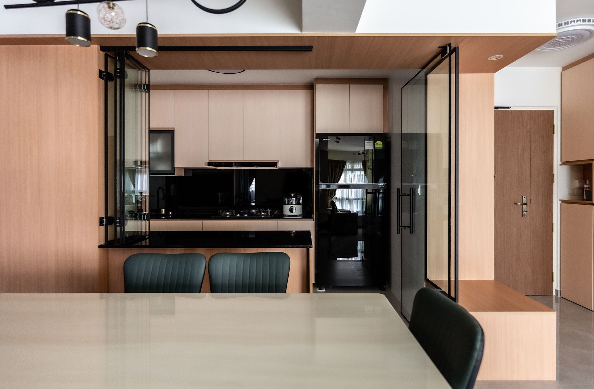 A kitchen with a table and chairs and a refrigerator.