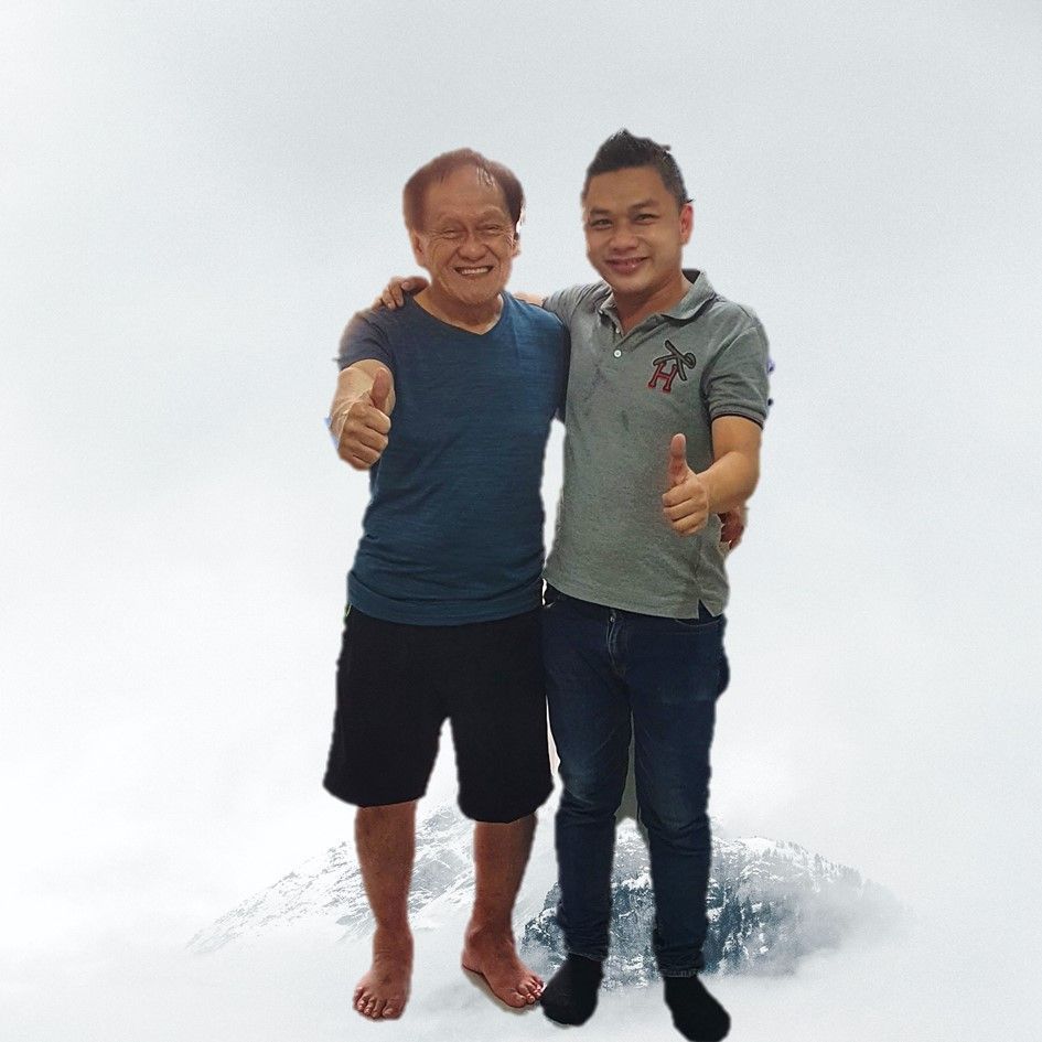 Two men are posing for a picture and one of them is wearing a shirt with the letter t on it