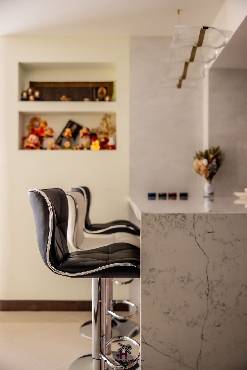 Two bar stools are sitting next to a counter in a kitchen.