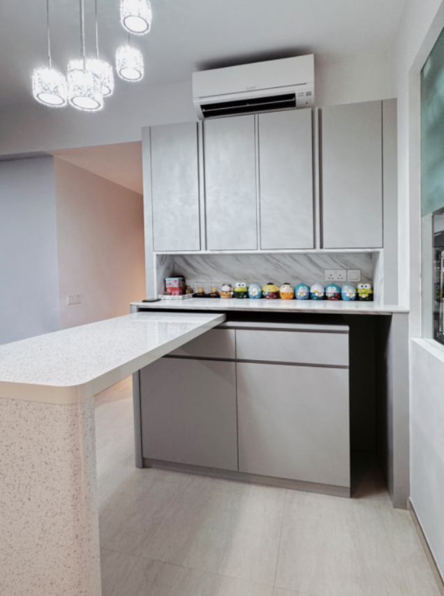 A kitchen with white cabinets and a white counter top.