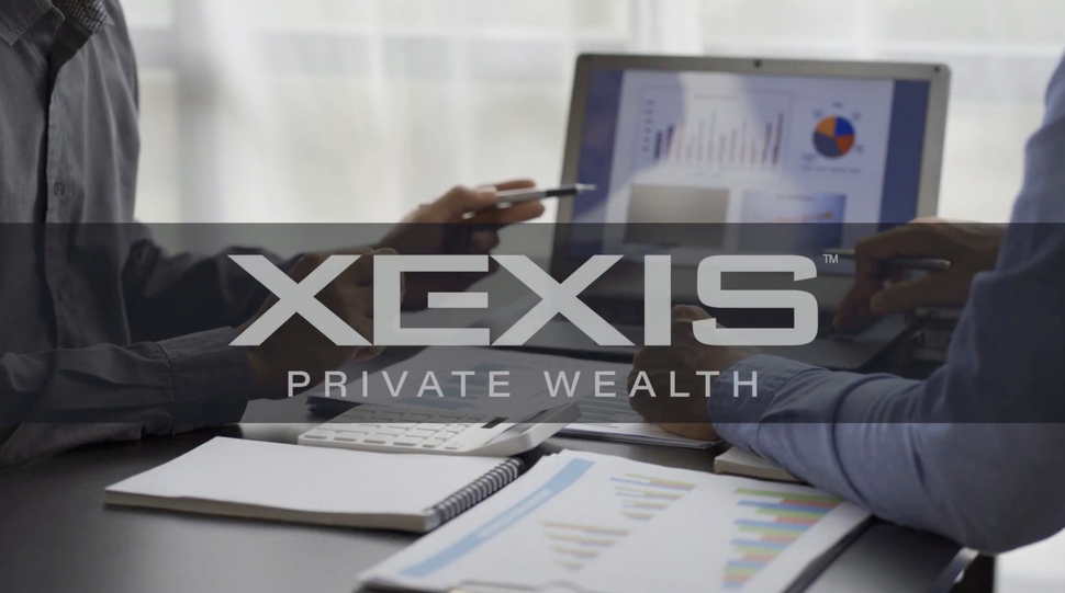 XEXIS Private Wealth branding over a business meeting with a laptop showing charts and a notebook.