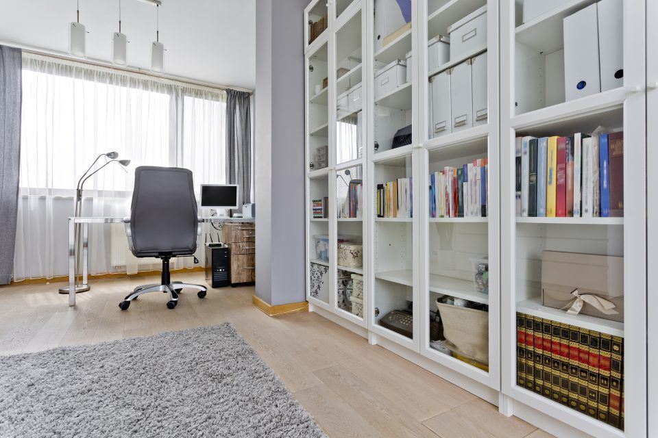 a small room consist of white color book shelf