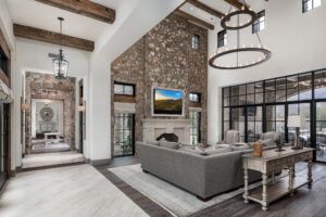 A living room with a large couch , fireplace and television.