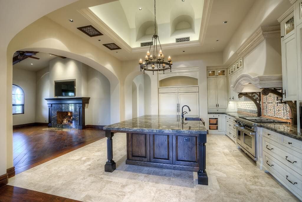 A kitchen with a large island and a fireplace