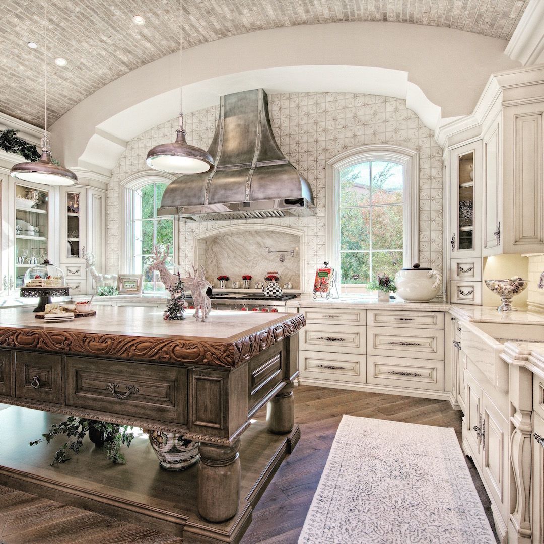 Traditional gourmet kitchen with large island and white cabinetry