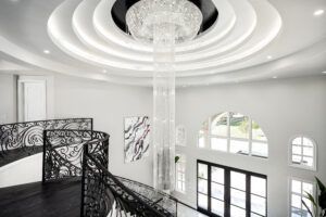 There is a large chandelier hanging from the ceiling in the middle of the room.