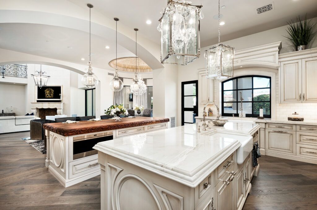 A large kitchen with white cabinets and a large island in the middle.