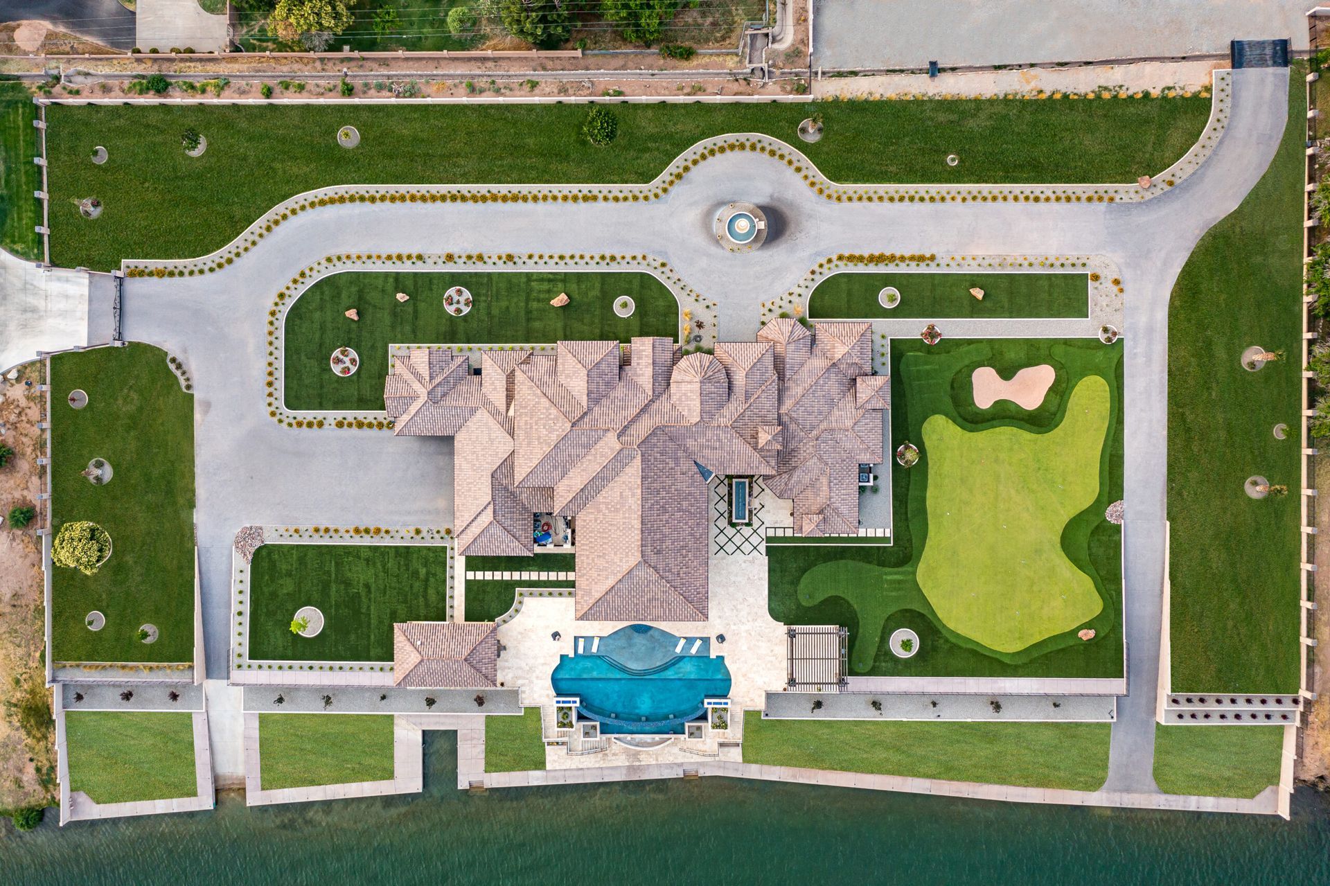 An aerial view of a large house with a golf course