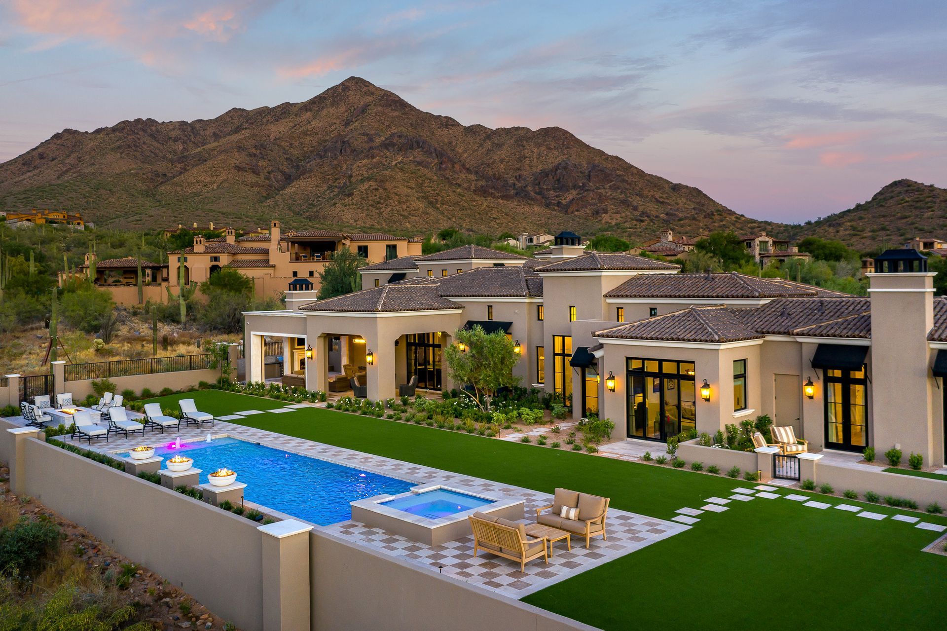 A large house with a large swimming pool in front of it