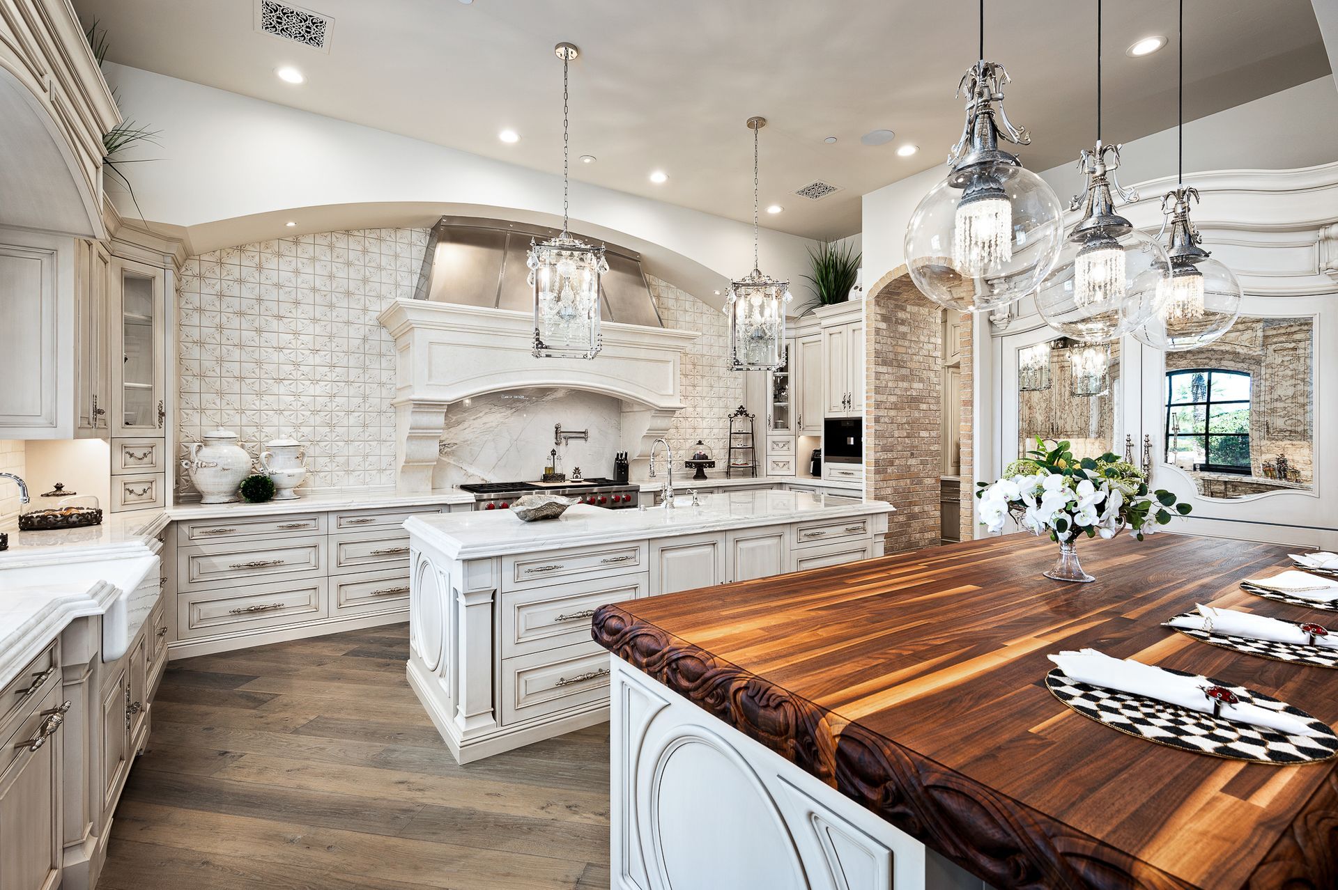 A kitchen with white cabinets and a wooden counter top.
