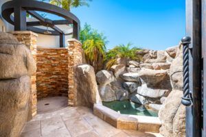 There is a waterfall in the background and a shower in the foreground.