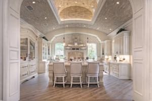 A kitchen with a large island and chairs in it