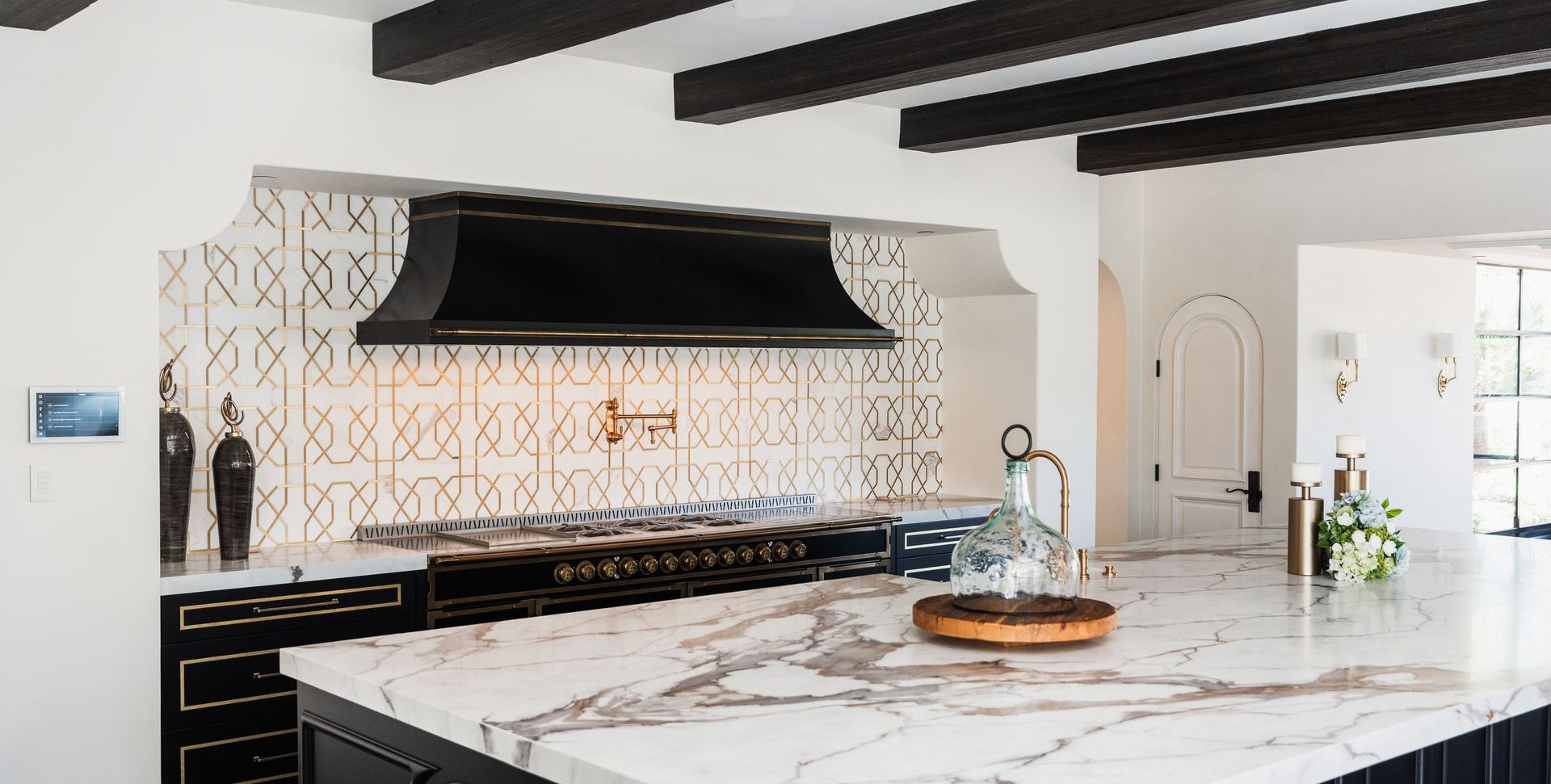 A kitchen with a large island and a stove top oven.