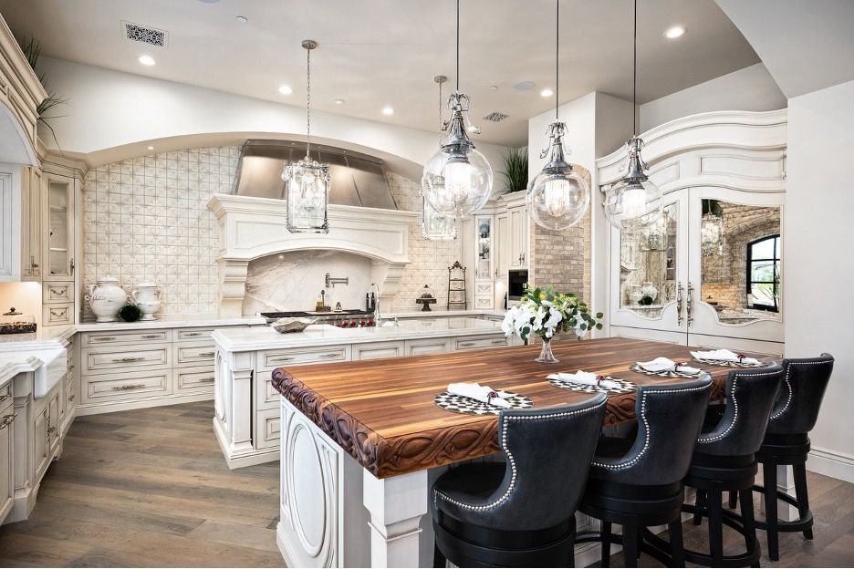 A large kitchen with a large wooden table and chairs.