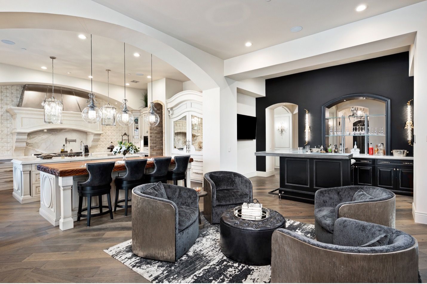 A living room filled with furniture and a kitchen in a house.