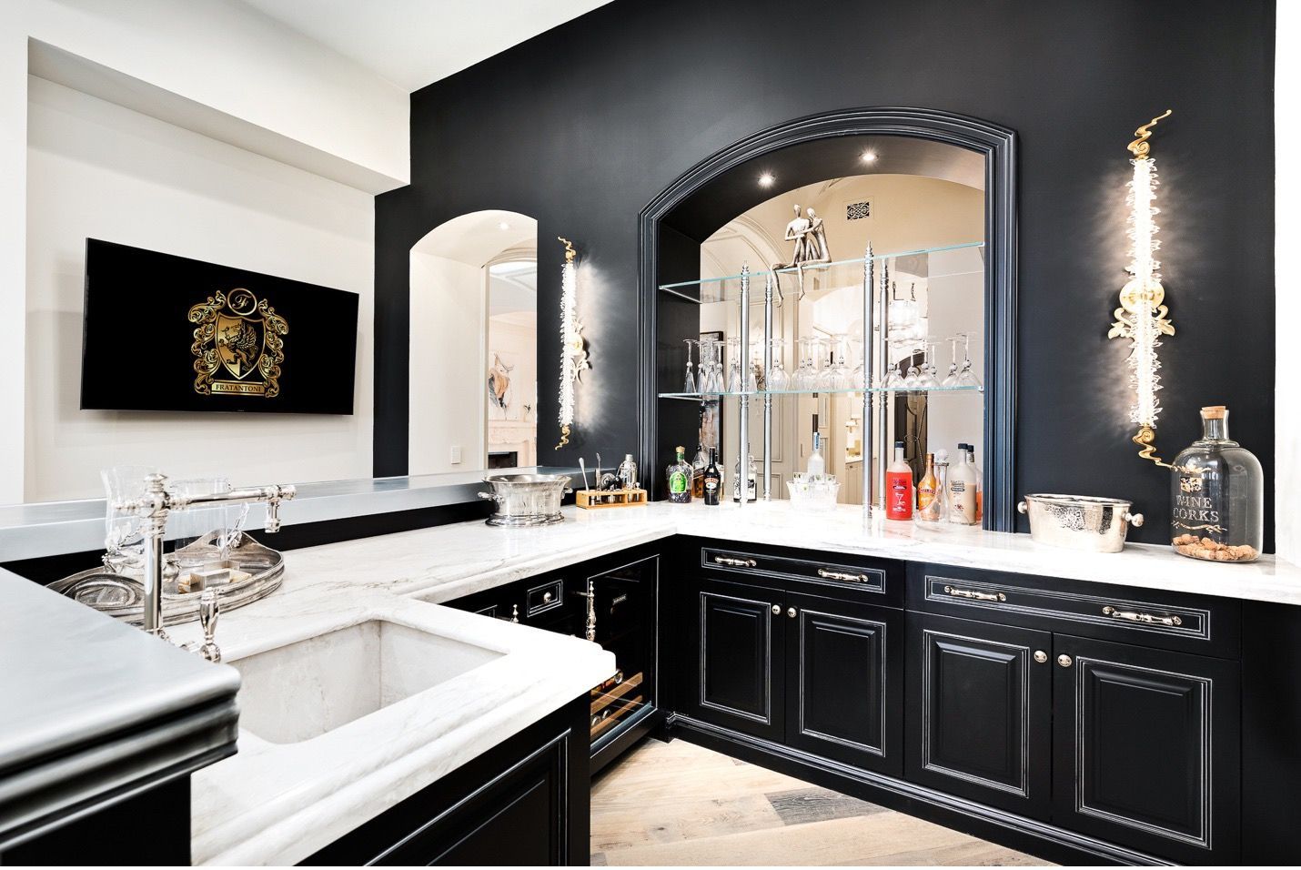 A kitchen with black cabinets and white counter tops