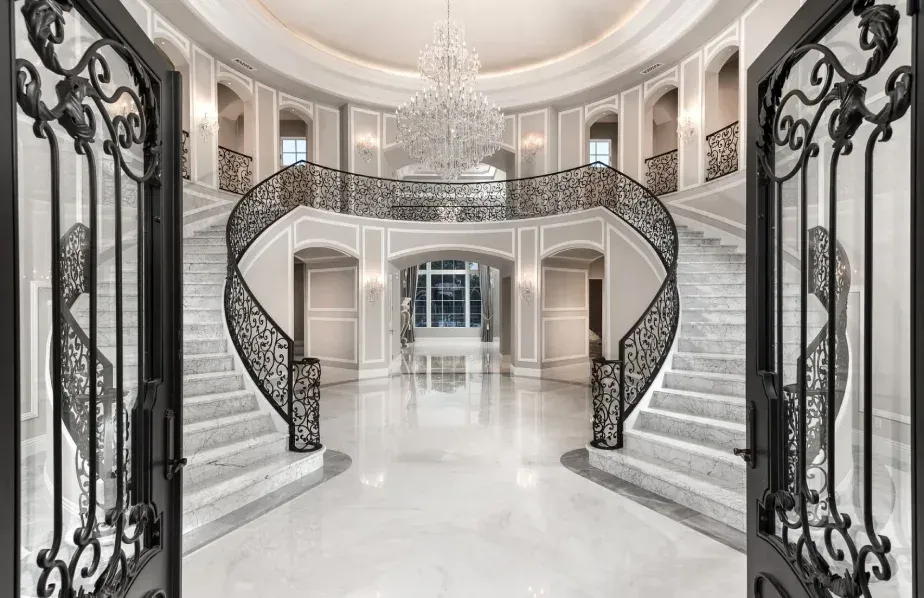 double staircase and chandelier in a luxury Mediterranean home