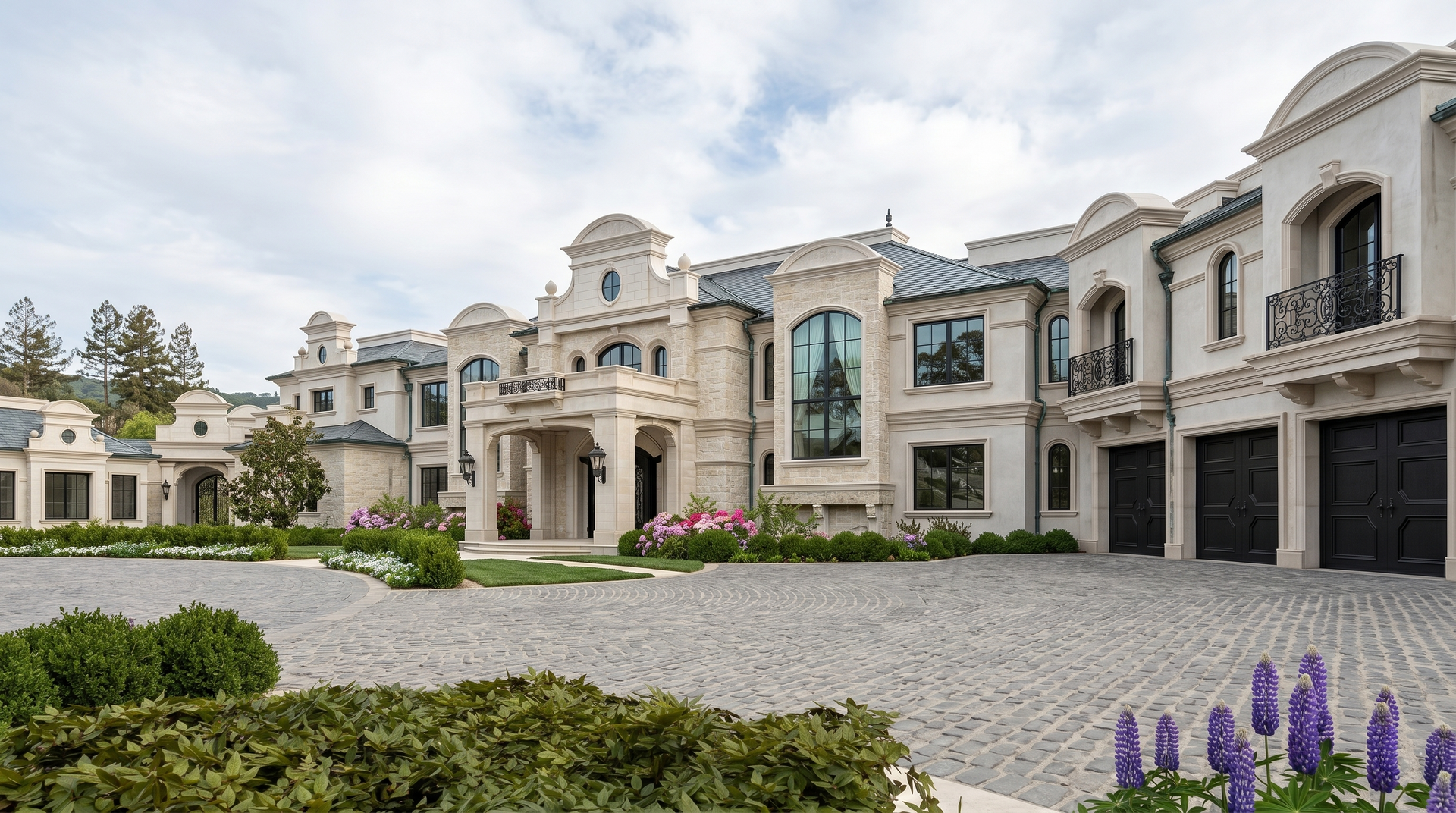 Large luxury modern mansion at dusk with lit windows, arched resort style backyard entryway, and reflecting fountain in front.