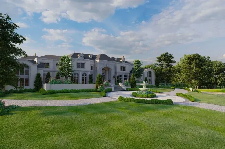 Custom luxury home exterior with circular driveway, landscaped borders, and in-ground lighting